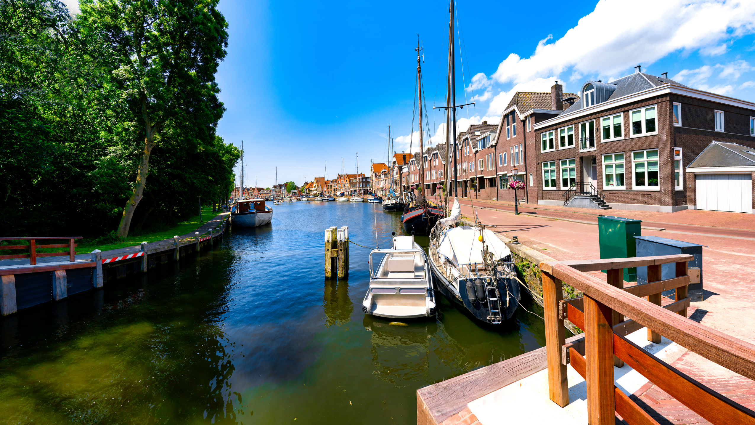 Sailing ships and dutch buildings by the Hoofdtooren in Hoorn, Netherlands by the Hoofdtooren in Hoorn, Netherlands