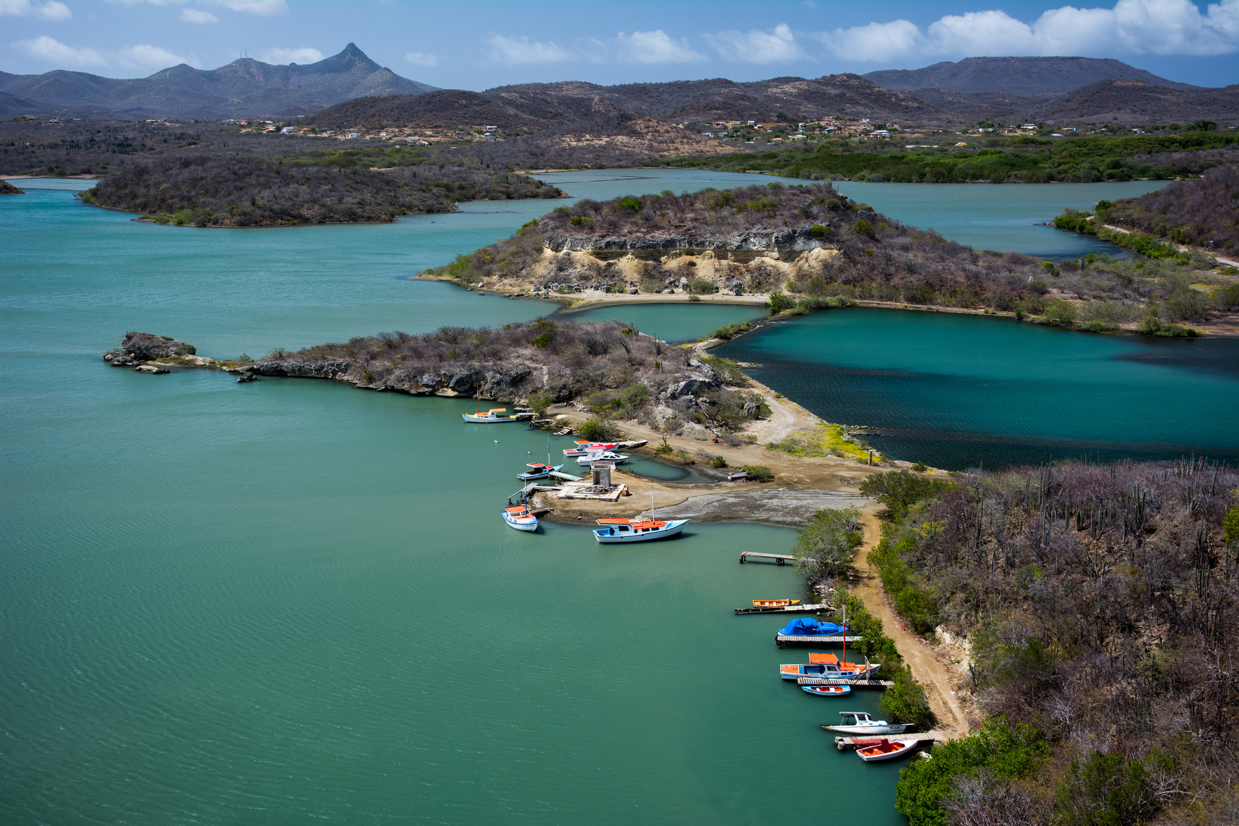 Aerial Photography of Boats Beside Road Under Blue Sky