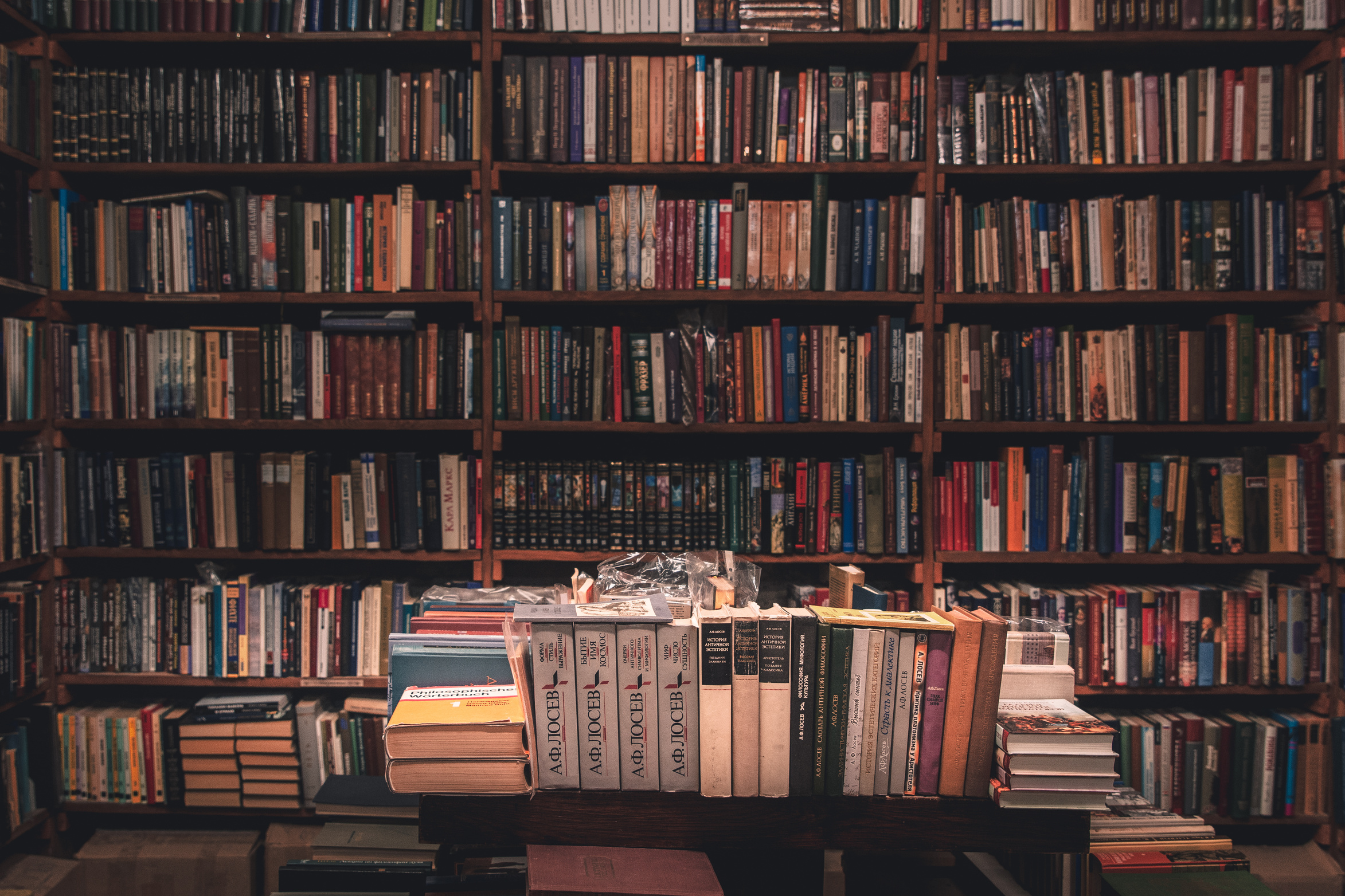 Books on Wooden Shelves Inside Library